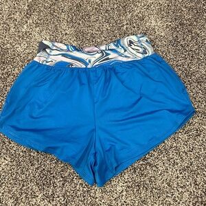 Blue athletic shorts with tight swirl waistband